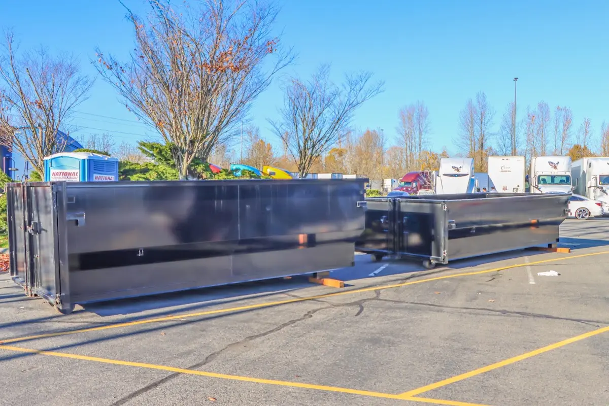 Professional dumpster rental service with roll-off container on residential driveway in Redding